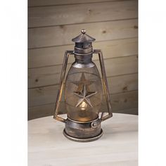 an old fashioned metal lantern on a table