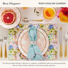 an image of a place setting with flowers and fruit on the table, including grapefruits