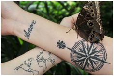 two butterflies sitting on top of each other's arm with words written on them