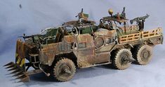 an old toy army vehicle with two soldiers on top