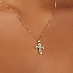 Introducing the Evelyn Cross Necklace, a piece where classic faith meets modern elegance. Adorned with sparkling cubic zirconia stones that catch the light with every turn, this necklace is a testament to timeless devotion and contemporary style. The delicate gold chain holds the cross pendant gracefully, making it a subtle yet striking addition to any ensemble. Whether as a personal symbol of faith or a gift of spiritual significance, the Evelyn Cross Necklace is sure to be cherished.  Hypoallergenic, nickel, and lead-free; Tarnish resistant. Made of 14K gold over sterling silver. High-grade Cubic Zirconia stones. Personal Symbol, Delicate Gold Chain, Forever Jewelry, Nail Jewelry, Jewelry Ring Box, Men's Jewelry Rings, Watch Necklace, Jewellery Boxes, The Cross