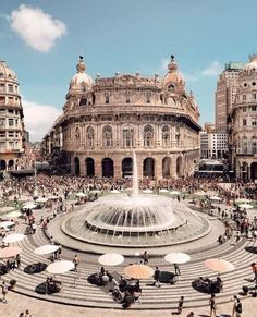 a large fountain surrounded by lots of people