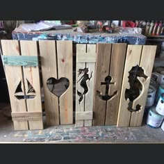 three wooden doors with seahorses on them and the words poshmark written in black