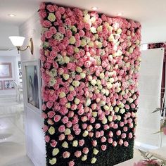 a wall made out of pink and white flowers