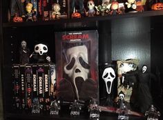 a shelf filled with halloween movies and figurines