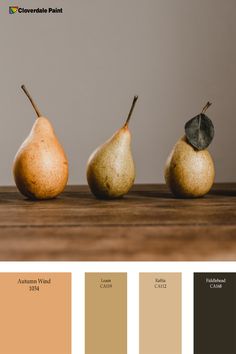 three pears are sitting on a table with different colors in the same color scheme