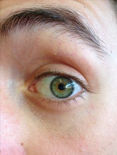 a close up of a person's blue eye