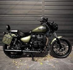 a motorcycle parked in front of a garage door with no one on it's bike