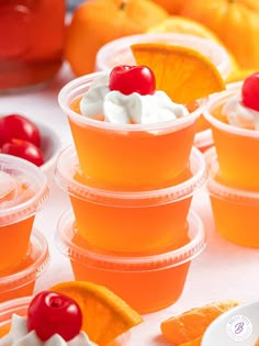 orange cups with whipped cream and cherries on them