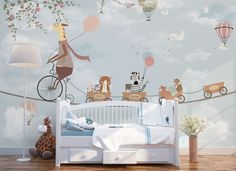 a child's bedroom decorated in blue and white with animals on a wire above the bed