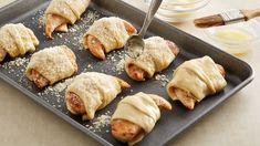 a pan filled with pastries sitting on top of a table