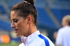 a female soccer player is looking at her cell phone