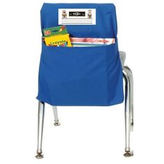 a blue school chair with a book pocket on it's back and some books in front of it