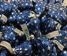 blue and gold stars are wrapped in brown paper with white writing on them, as well as some type of candy