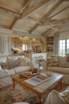 a living room filled with white furniture and lots of wood beamed ceilinging on the walls