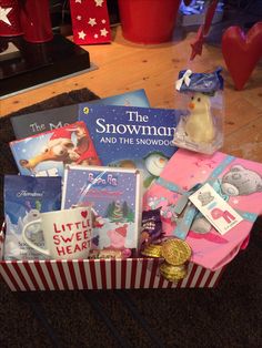 the snowman and the snowwolves gift box is filled with books, toys, and gifts