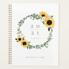 a spiral notebook with sunflowers and greenery around the numbers twenty - two