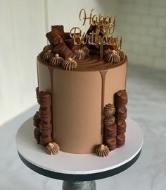 a birthday cake with chocolate icing and decorations