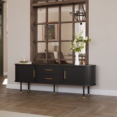 a large mirror is on the wall above a black cabinet