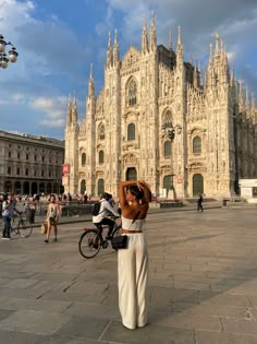 a woman standing in front of a large building