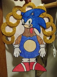 a cardboard cutout of sonic the hedgehog with gold rings around it's neck