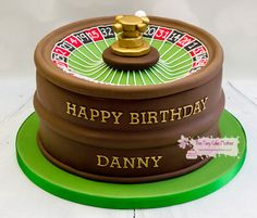 a birthday cake with a rouleet on top and the words happy birthday danny