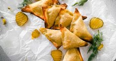 several pastries on wax paper with lemons and dill