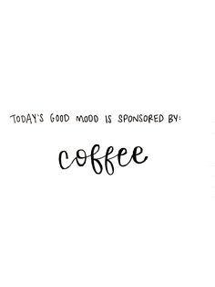 a coffee cup sitting on top of a wooden table next to a white wall with the words, today's good mood is sponsored by coffee