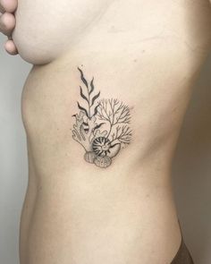 a woman's stomach with a tattoo on it