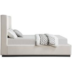 a white bed with two pillows on top of the headboard and bottom foot board