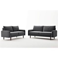 two gray couches sitting next to each other on top of a white flooring