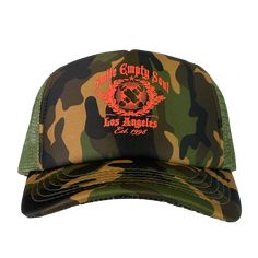 An adjustable unisex snap back trucker hat in green camo, and olive green netting with Smile Empty Soul "EST 1998" graphic printed on the front in red. One size fits most. Camouflage Baseball Cap With Curved Bill For Streetwear, Streetwear Camouflage Baseball Cap With Curved Bill, Camouflage Trucker Hat With Curved Bill, Curved Bill Camouflage Hats For Streetwear, Camouflage Trucker Hat For Sports, Military Style Trucker Hat, One Size Fits Most, Military Style Trucker Hat One Size Fits Most, Camouflage Snapback Trucker Hat For Sports, Military Style Snapback Hat For Streetwear