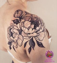 a woman's shoulder with black and white flowers on it