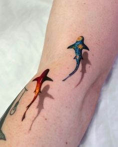 a woman's arm with two birds on it