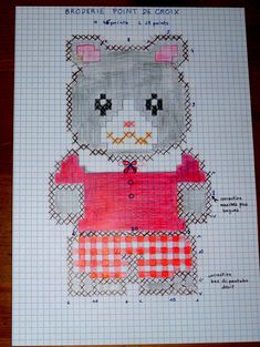 a cross stitch pattern of a teddy bear wearing a red shirt and checkered skirt