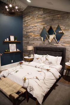 a bed with white sheets and pillows next to a wooden shelf filled with pictures on the wall