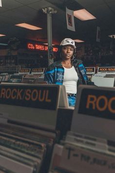 a woman standing in front of some old records