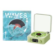 a green record player sitting in front of a box with the words waves on it