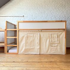 a bunk bed with two mattresses and a ladder