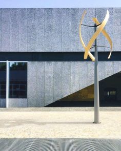 a metal sculpture in front of a building