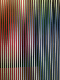 a multicolored wall with vertical lines on it