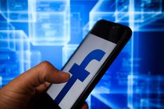 a hand holding a cell phone with the facebook logo on it and an abstract background