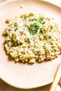 a white plate topped with rice covered in parmesan