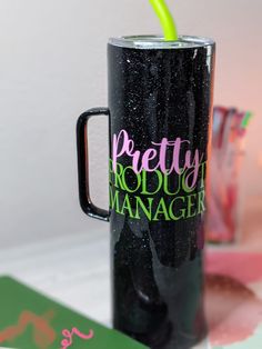 there is a black coffee cup with a green straw in it and the words pretty product manager on it