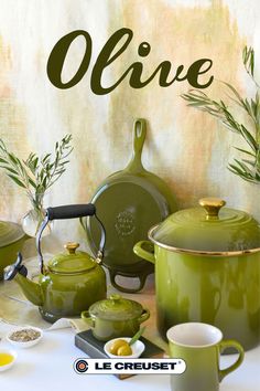 green pots and pans on a table with the words olive written in large letters