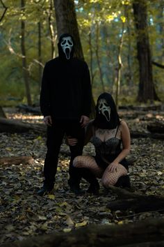 a man and woman dressed up as ghost in the woods