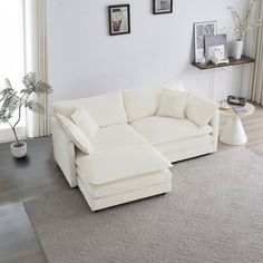 a white couch sitting on top of a rug in a living room