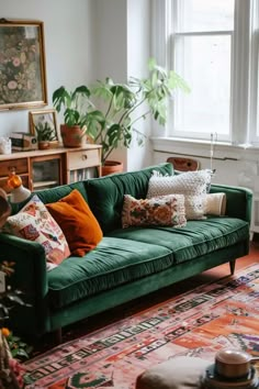 a living room filled with lots of green furniture and pillows on top of a rug