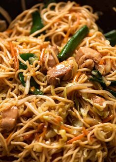 noodles with meat and vegetables in a wok