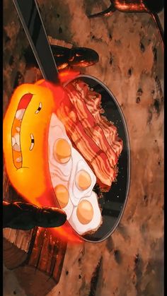 bacon, eggs and bacon on a black plate with an orange pumpkin as the background